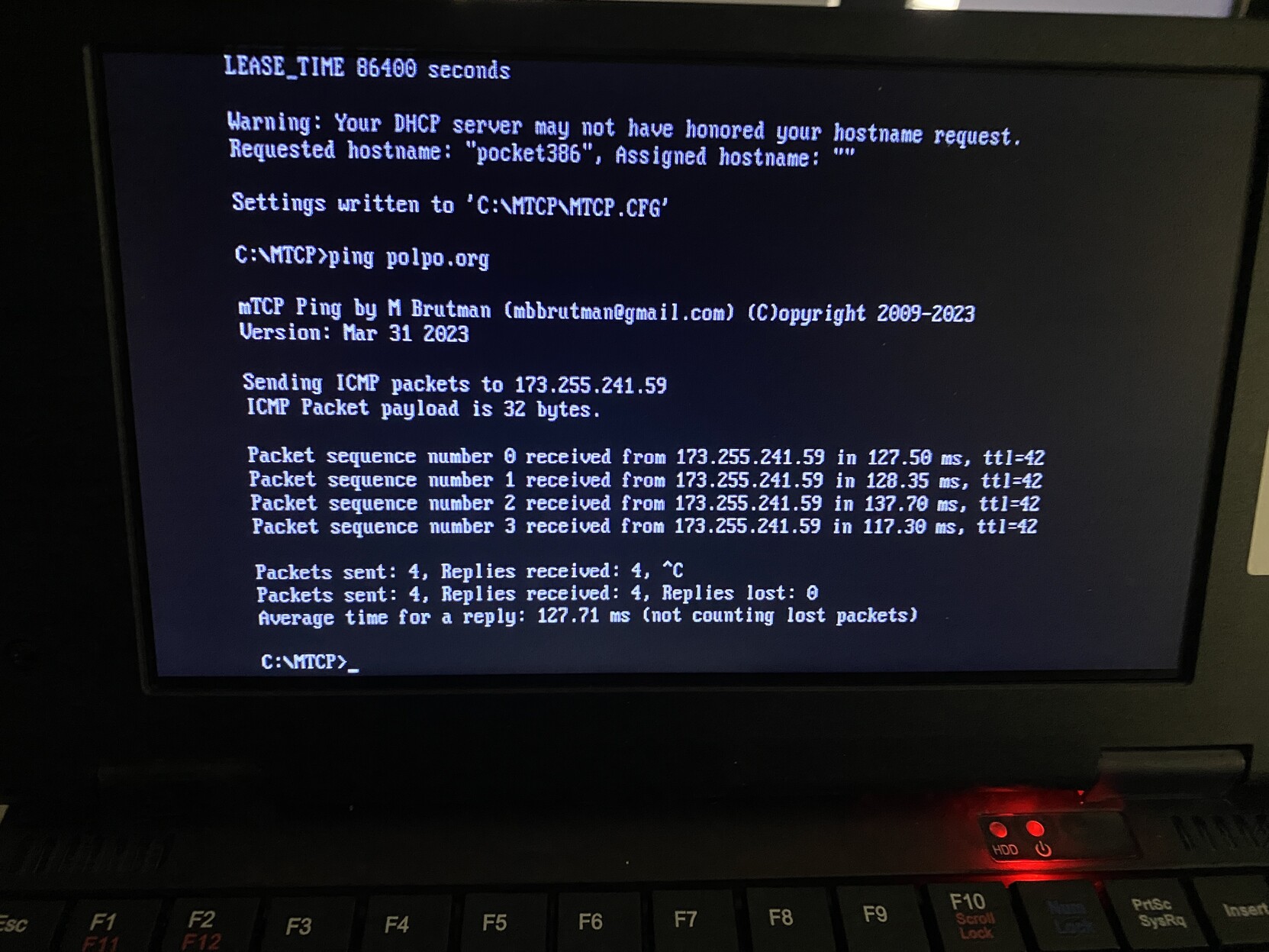 The screen of the Pocket386 showing getting a DHCP lease and pinging polpo.org