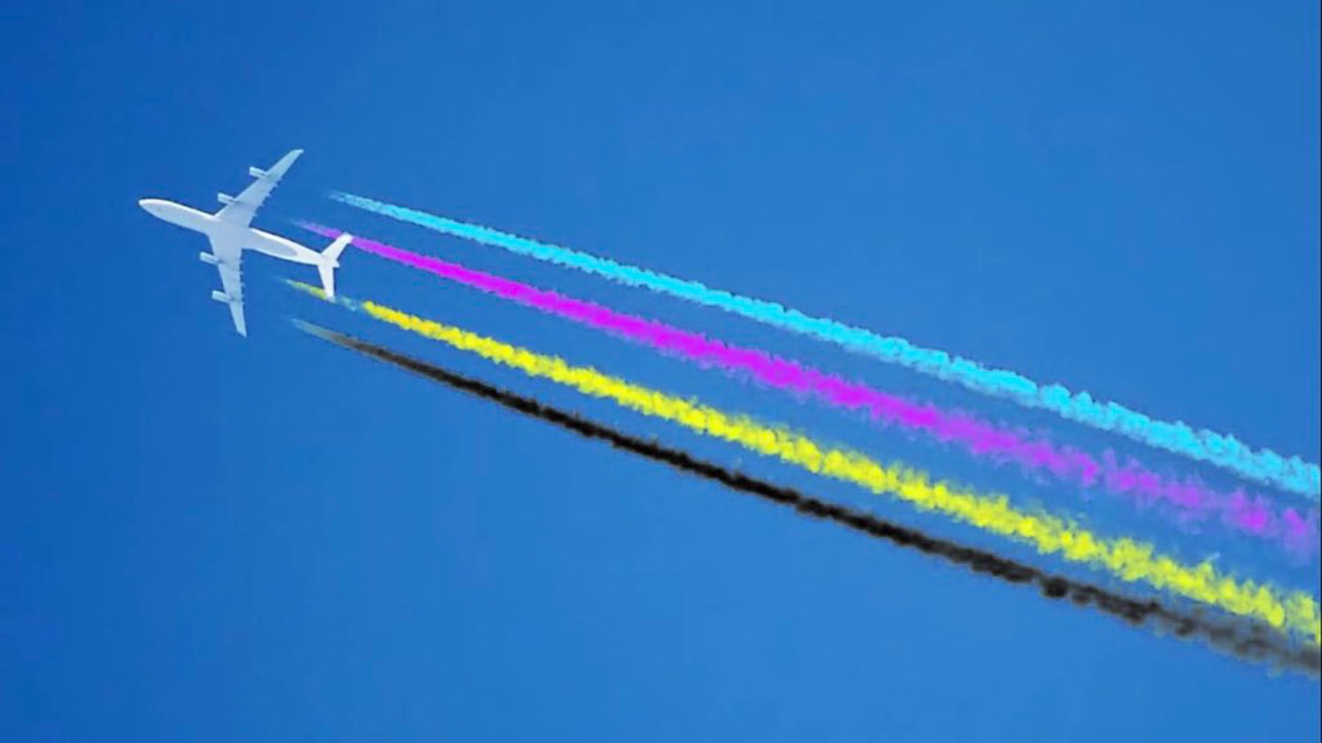 A photo looking up at a jet in the sky flying past and it has four contrails behind in the colours cyan magenta yellow and black.