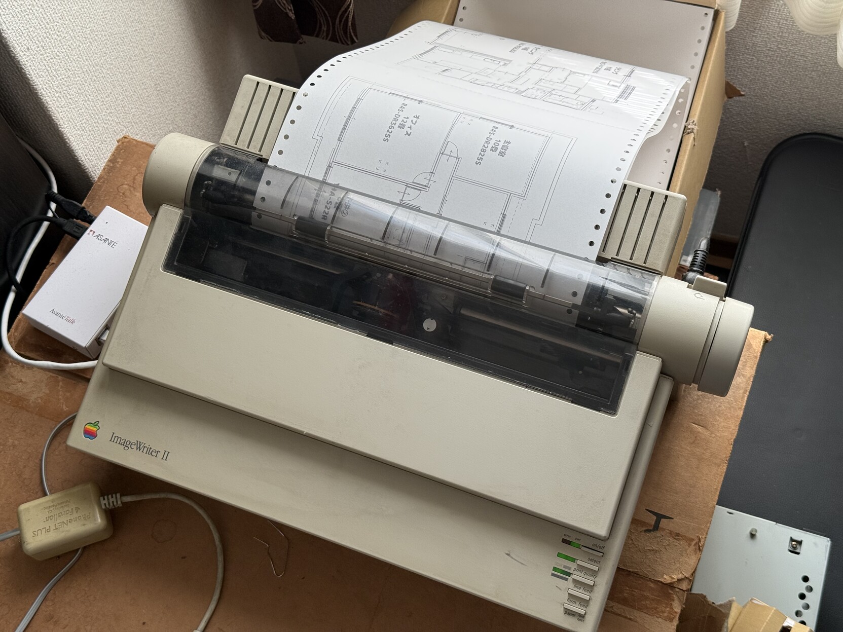 An Apple ImageWriter printing out a blueprint