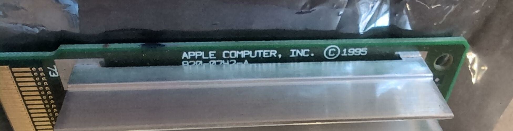 A closeup of the edge of an ASPD card, showing the text printed on the board, half under the cooling fins. It reads Apple Computer, Inc copyright 1995 820-0742-A.